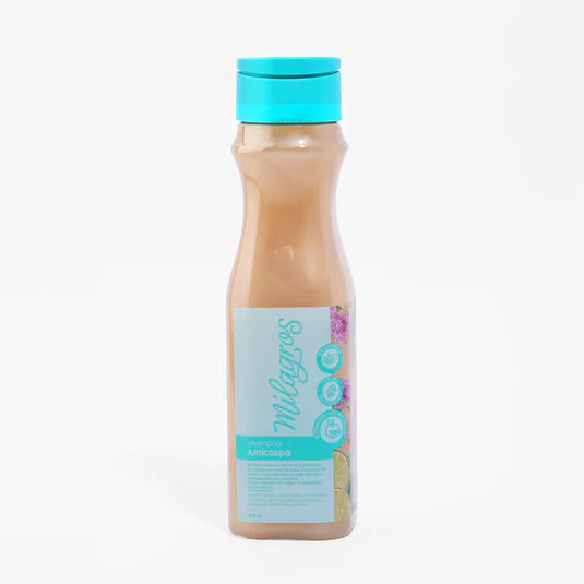 A tall, clear plastic bottle with a blue cap and label contains Shampoo Anticaspa by Milagros; the label features the brand name and fruit images.